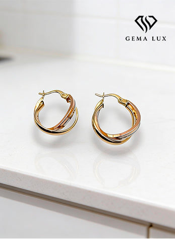 Aros danity retorcidos en oro de 14 k con detalles en amarillo, blanco y rosa.
